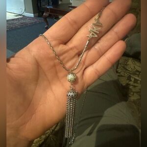 Aka necklace with aka logo and flower logo